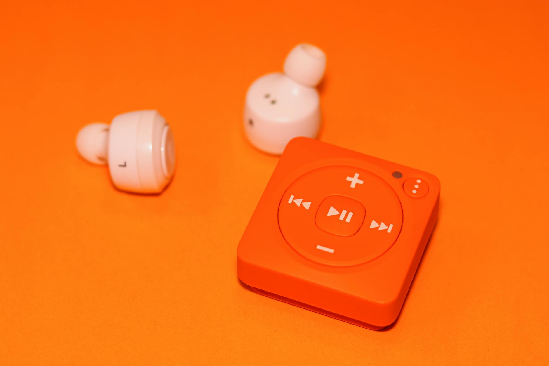 https://www.pexels.com/photo/white-earphones-beside-orange-music-player-3194469/